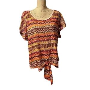 Pretty Rebellious chevron eyelet cutout top with rolled sleeves and tie front..